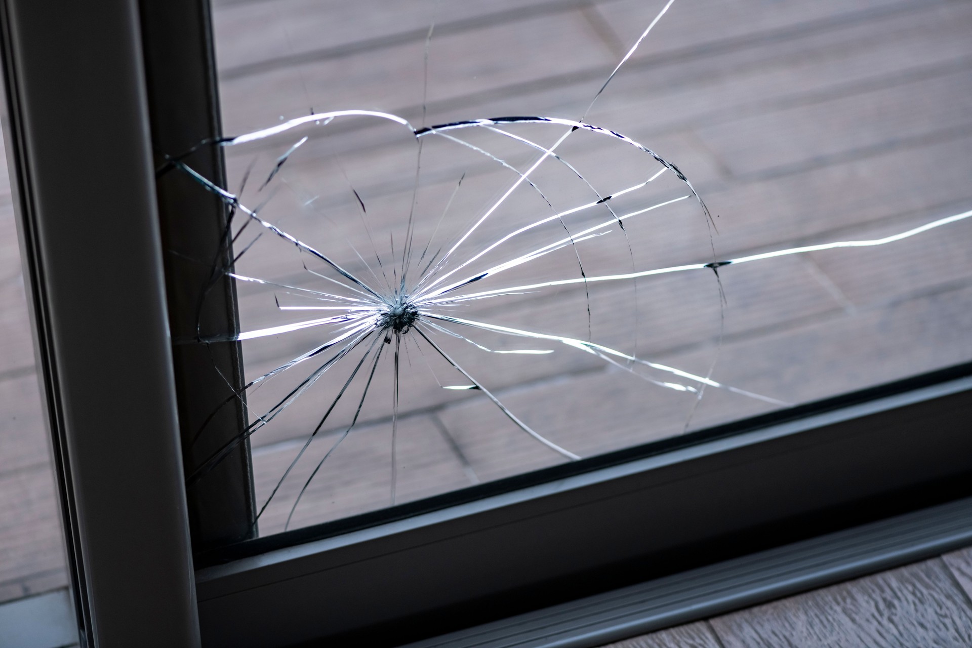 Cracked door glass in close-up.
